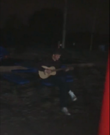 Ari plays his guitar